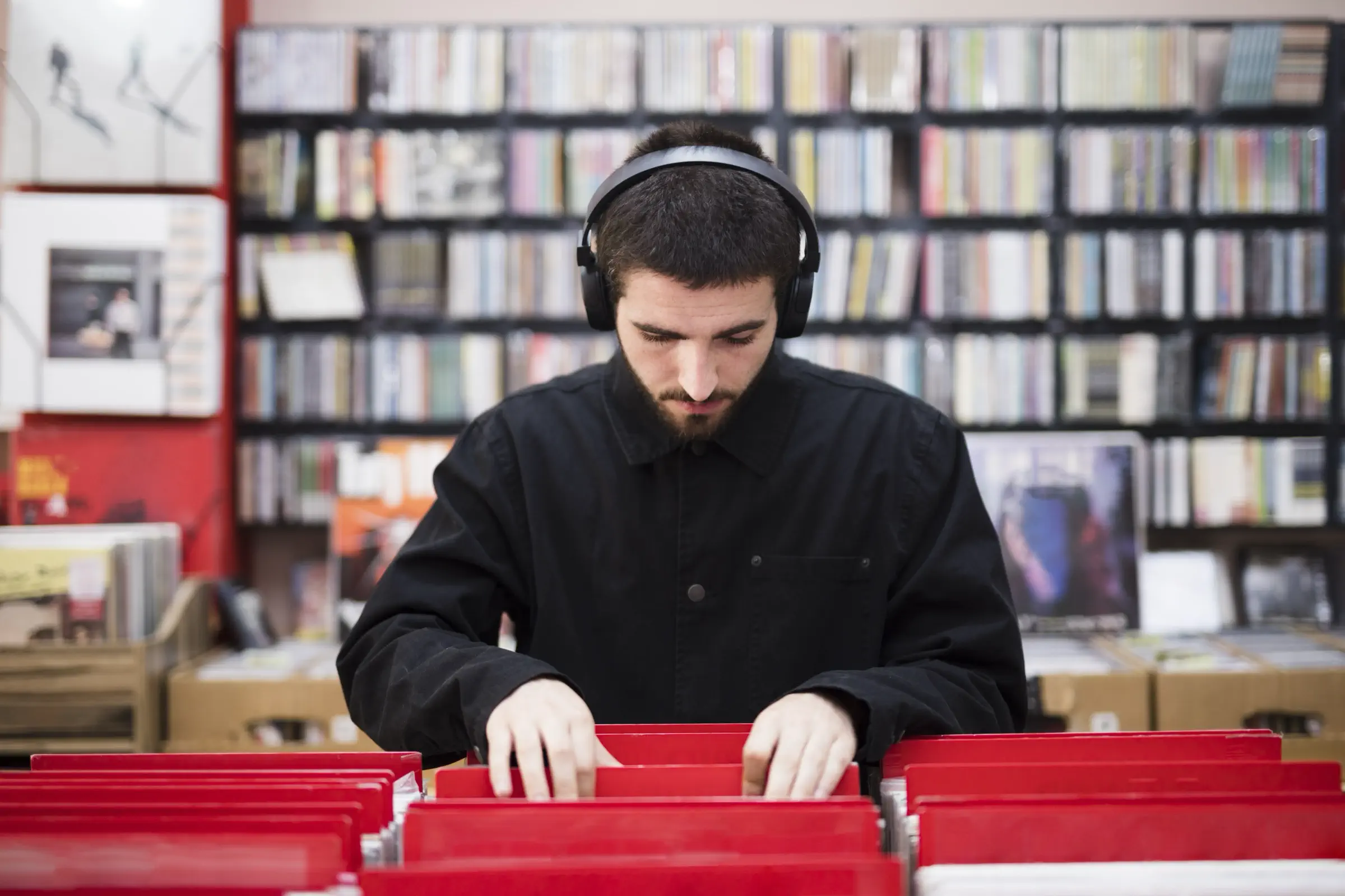 medium-shot-young-man-looking-vinyls-store